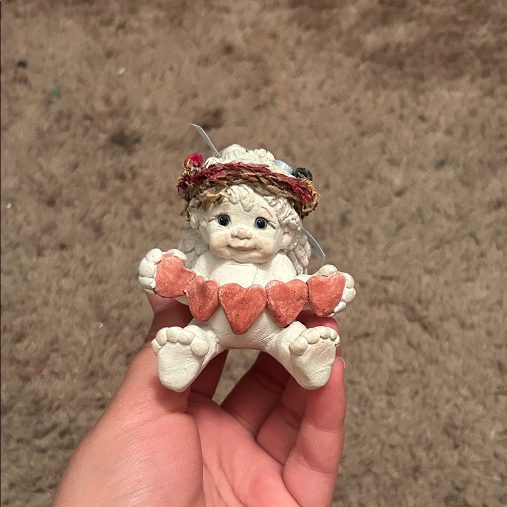 Adorable Cherub Figurine with Heart Garland